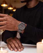 Clicöt Apollo 41mm watch in grey on a man's left wrist, everyday lifestyle photo