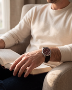 Clicöt Ares 41mm watch in red and black on a man's left wrist, everyday lifestyle photo