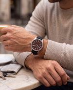 Close-up of the Clicöt Ares 41mm watch in red and black on a man's left wrist