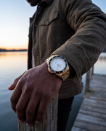 Clicöt Astra 42mm unisex watch in black, white and gold, worn on the left wrist