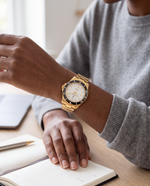 Clicöt Astra 42mm watch in black, white and gold on the left wrist, everyday lifestyle photo