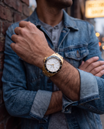 Close-up of the Clicöt Astra 42mm watch in black, white and gold on the left wrist