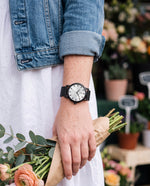 Clicöt Athena 36mm watch in black and white on a woman's left wrist, everyday lifestyle photo