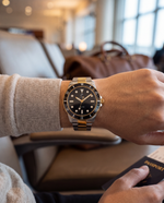 Close-up of the Clicöt Aurora 42mm watch in black, gold and silver on the left wrist