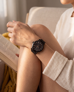 Clicöt Erebus 36mm women's watch in black, worn on a woman's left wrist