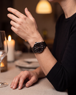 Clicöt Erebus 36mm watch in black on a woman's left wrist, everyday lifestyle photo