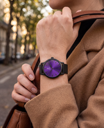 Clicöt Eris 36mm women's watch in black and purple, worn on a woman's left wrist
