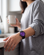 Close-up of the Clicöt Eris 36mm watch in black and purple on a woman's left wrist