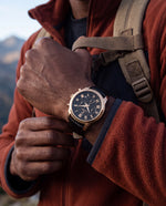 Clicöt Helios 42mm men's watch in black and gold, worn on a man's left wrist