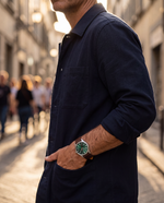 Clicöt Hermes 41mm men's watch in green, brown and silver, worn on a man's left wrist