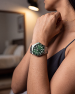 Clicöt Horizon 42mm watch in green and silver on the left wrist, everyday lifestyle photo