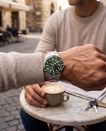 Close-up of the Clicöt Horizon 42mm watch in green and silver on the left wrist