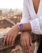 Clicöt Iris 36mm women's watch in purple and silver, worn on a woman's left wrist