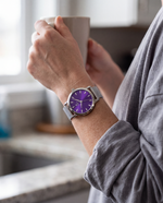 Clicöt Iris 36mm watch in purple and silver on a woman's left wrist, everyday lifestyle photo