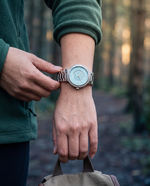 Clicöt Liane 36mm women's watch in blue and silver, worn on a woman's left wrist