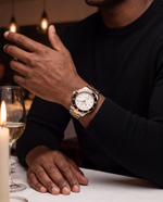 Close-up of the Clicöt Lumen 42mm watch in black, white, gold and silver on the left wrist