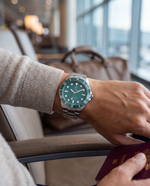 Clicöt Luna 42mm unisex watch in teal and silver, worn on the left wrist