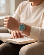 Clicöt Luna 42mm watch in teal and silver on the left wrist, everyday lifestyle photo