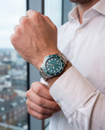 Close-up of the Clicöt Luna 42mm watch in teal and silver on the left wrist