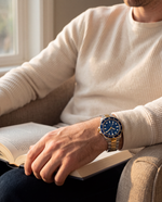 Close-up of the Clicöt Meridian 42mm watch in navy, gold and silver on the left wrist