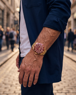 Clicöt Mirage 42mm unisex watch in red and gold, worn on the left wrist