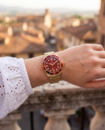 Clicöt Mirage 42mm watch in red and gold on the left wrist, everyday lifestyle photo