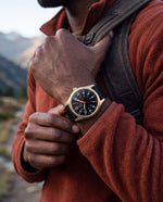 Clicöt Moros 41mm watch in black and gold on a man's left wrist, everyday lifestyle photo