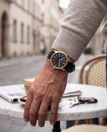 Close-up of the Clicöt Moros 41mm watch in black and gold on a man's left wrist