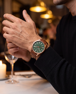 Clicöt Morpheus 41mm watch in green, brown and rose gold on a man's left wrist, everyday lifestyle photo