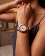 Clicöt Nova 42mm watch in pink, gold and silver on the left wrist, everyday lifestyle photo