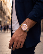 Close-up of the Clicöt Nova 42mm watch in pink, gold and silver on the left wrist