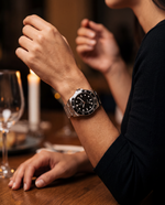 Clicöt Obsidian 42mm watch in black and silver on the left wrist, everyday lifestyle photo