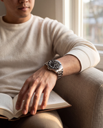 Close-up of the Clicöt Obsidian 42mm watch in black and silver on the left wrist