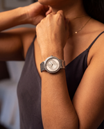 Clicöt Pandora 36mm women's watch in white and silver, worn on a woman's left wrist