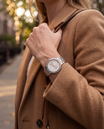 Close-up of the Clicöt Pandora 36mm watch in white and silver on a woman's left wrist