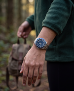 Clicöt Polaris 42mm watch in navy and silver on the left wrist, everyday lifestyle photo