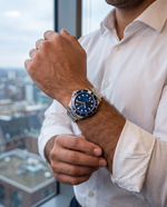 Close-up of the Clicöt Polaris 42mm watch in navy and silver on the left wrist