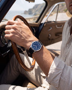 Clicöt Poseidon 41mm men's watch in navy and black, worn on a man's left wrist