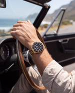 Clicöt Radiant 42mm unisex watch in black and gold, worn on the left wrist