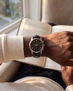 Close-up of the Clicöt Robin 42mm watch in black and silver on a man's left wrist