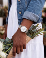 Clicöt Selene 36mm watch in silver on a woman's left wrist, everyday lifestyle photo
