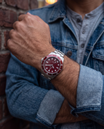 Clicöt Solara 42mm unisex watch in red and silver, worn on the left wrist