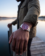 Close-up of the Clicöt Solara 42mm watch in red and silver on the left wrist