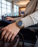 Clicöt Solstice 42mm unisex watch in navy and gold, worn on the left wrist