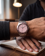 Close-up of the Clicöt Stella 42mm watch in pink and silver on the left wrist
