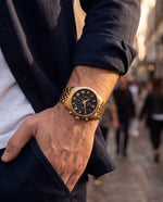 Close-up of the Clicöt Thor 42mm watch in black and gold on a man's left wrist