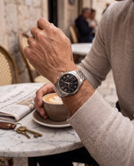 Clicöt Tristan 42mm men's watch in black and silver, worn on a man's left wrist
