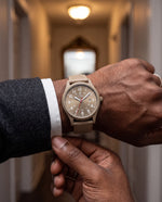 Clicöt Zeus 41mm watch in beige on a man's left wrist, everyday lifestyle photo